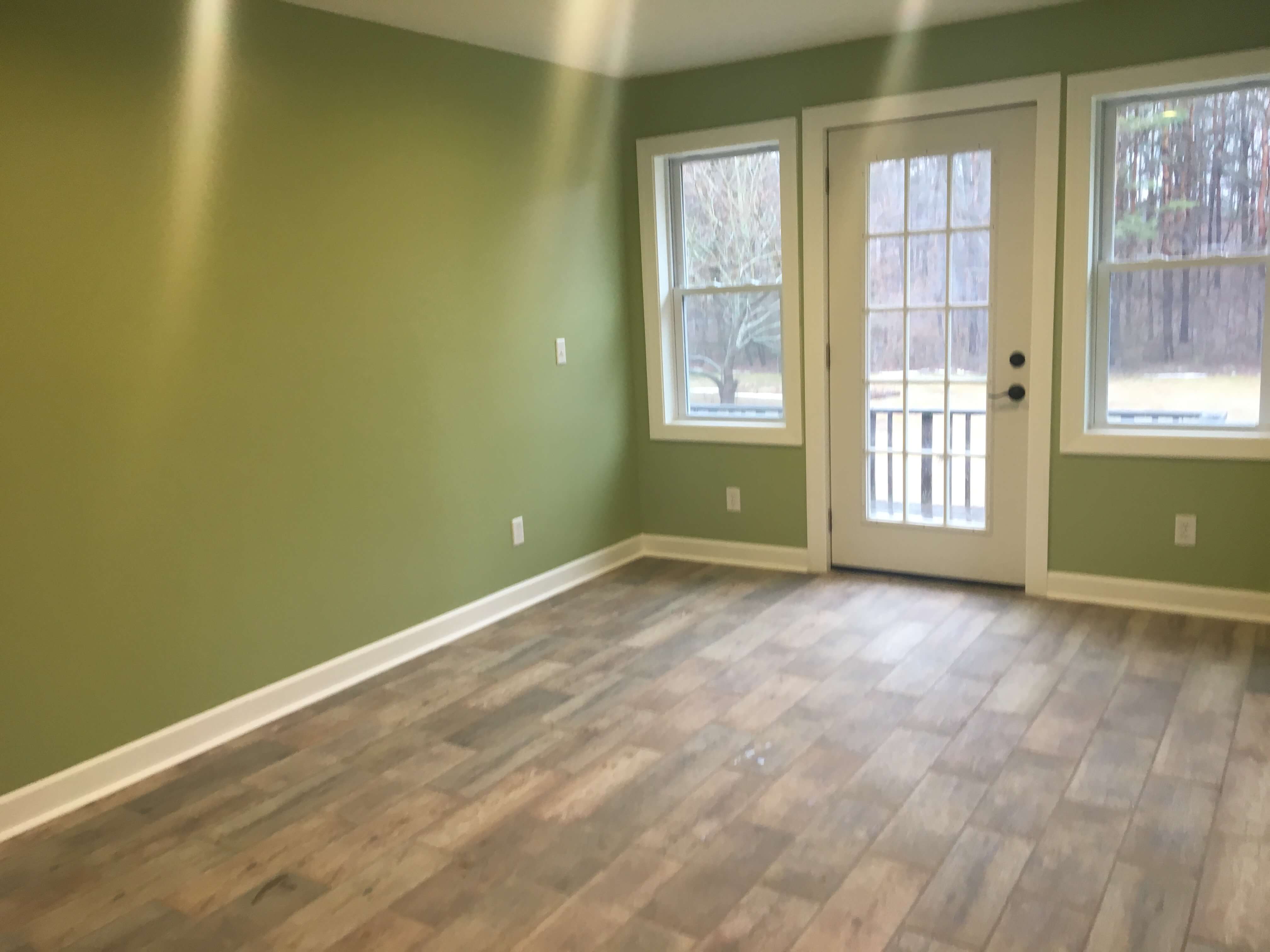 Finished room with new French door, trim and luxury vinyl plank floor